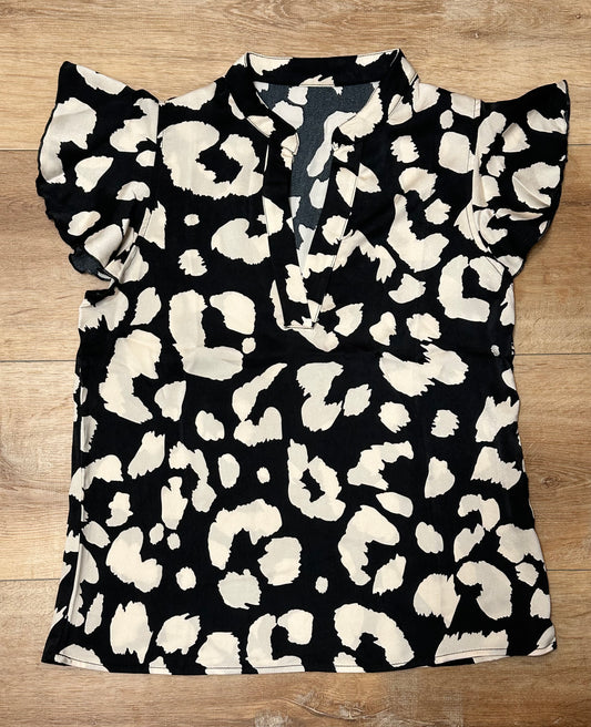 Blusa de animal print negra y crema